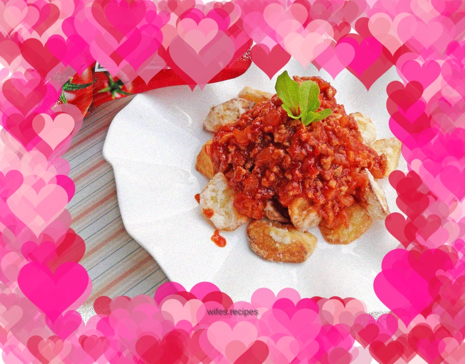 Homemade appetizer - potatoes with tomato sauce