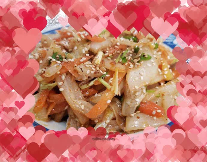 Shredded cabbage and carrots mixed with sesame oil